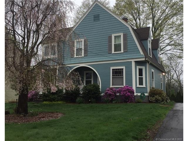 Front view with flowering perrenial bushes and tre