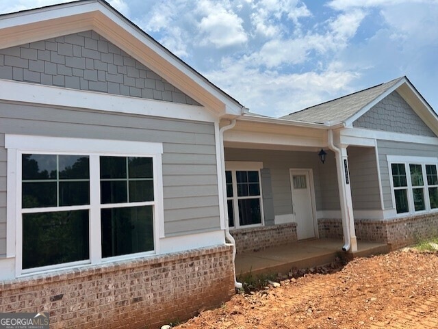 Front elevation, brick water table, Hardy plank siding, rocking chair porch