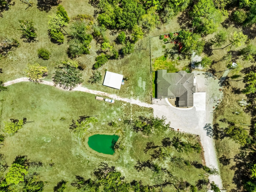 Enjoy a beautiful home on a quiet street, barn and stable, 15 ft. pond and unrestricted acreage!