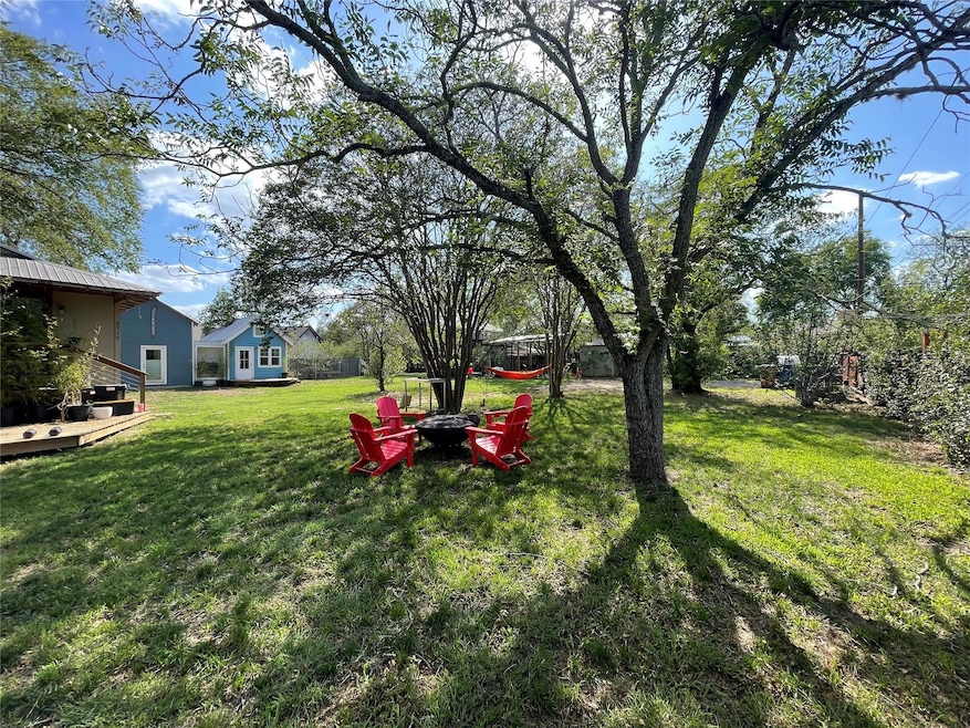View of green lawn with a fire pit