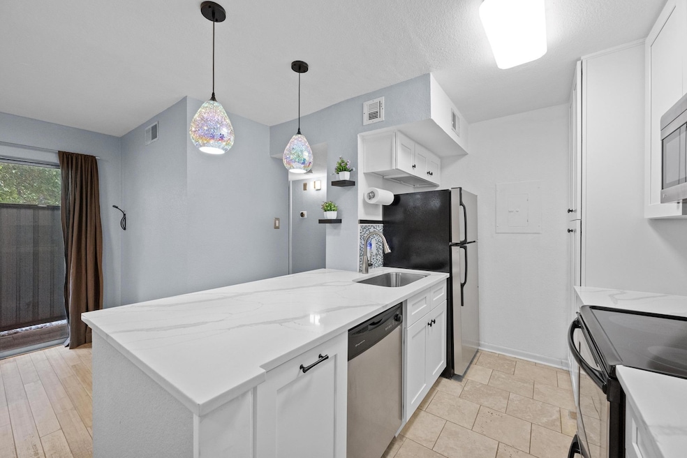 Kitchen featuring dishwasher, a peninsula, a sink