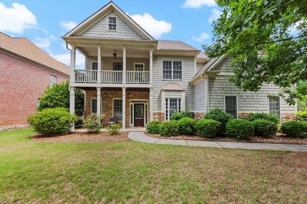 View of front of property featuring a balcony, a f