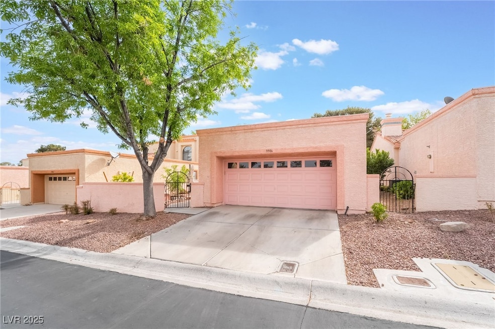 View of front of house with a gate, stucco siding,