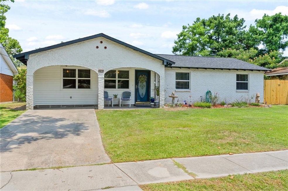 Front of home with porch, nice landscaping, birdba