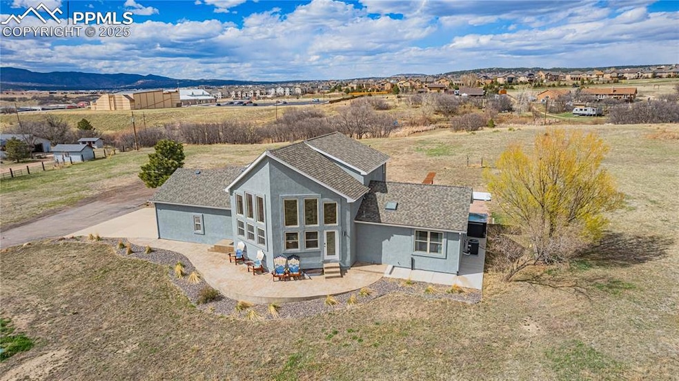 Located on a 5 acre subdividable lot in Academy school District #20, this 4 bedroom/4bath/4 car home has great views of both the front range and Pikes Peak.
