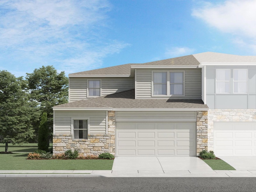 View of front of home with stone siding, driveway