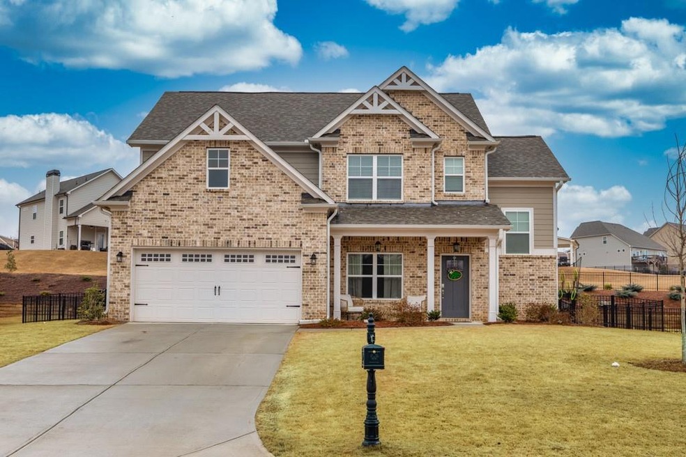 Craftsman-style house with a garage and a front ya