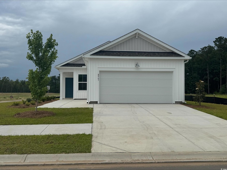 View of front of property with an attached garage, concrete driveway, and board and batten siding