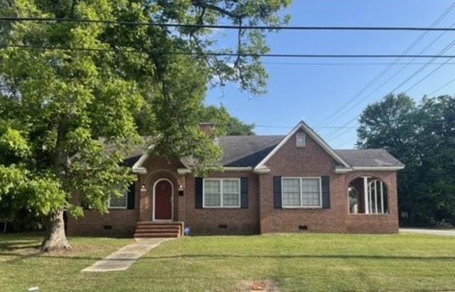 Bungalow-style house with a front lawn
