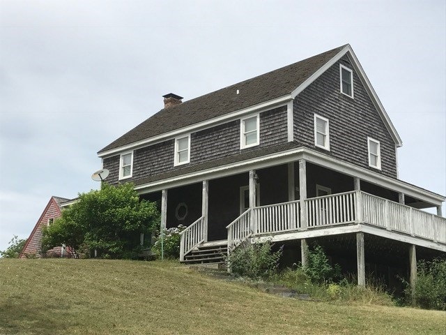 Colonial style exterior with decks and covered por