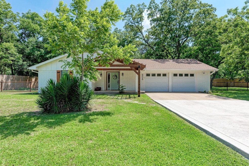 Ranch-style house featuring brick siding, an atta
