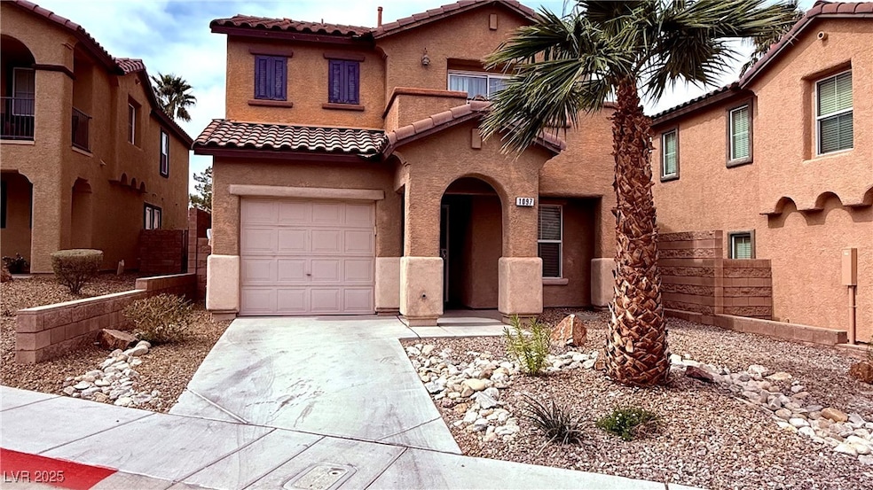 Mediterranean / spanish-style home featuring a gar