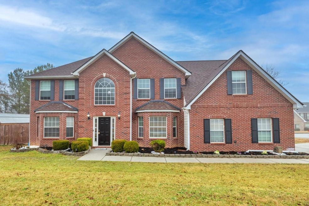 Colonial house featuring brick siding, a front yar
