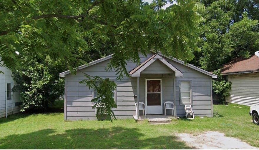 View of outbuilding with a lawn