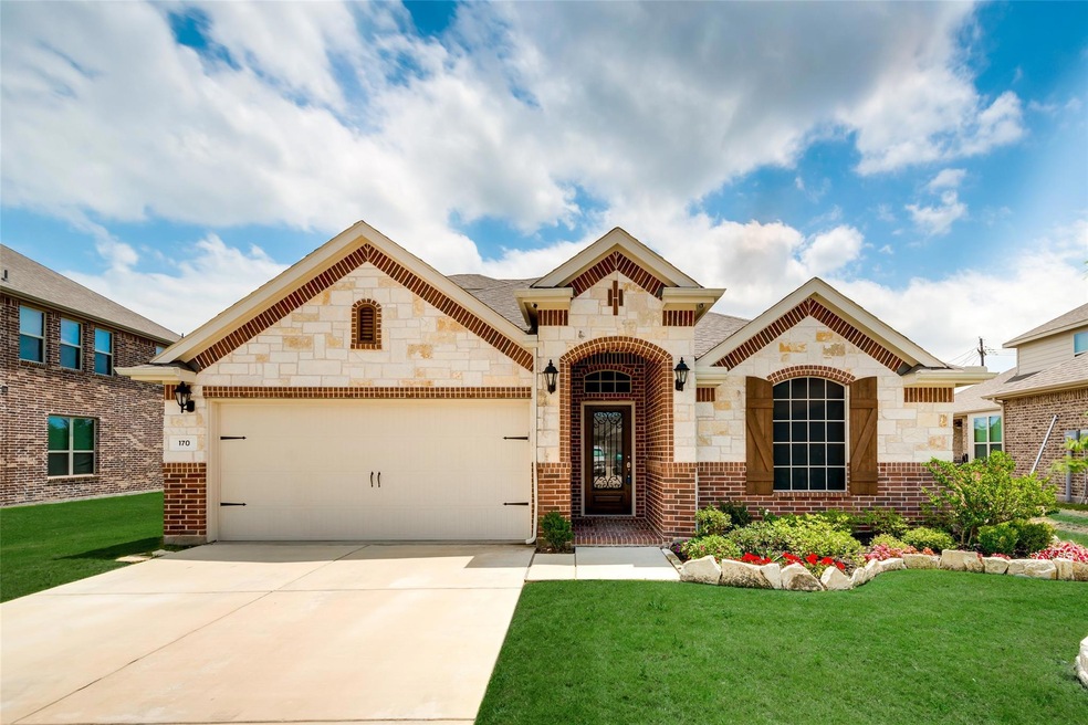 Mediterranean / spanish-style home with a garage and a front lawn