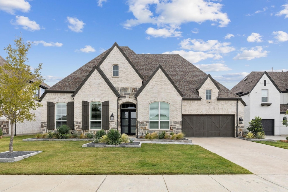 French country home with brick siding, stone sidin