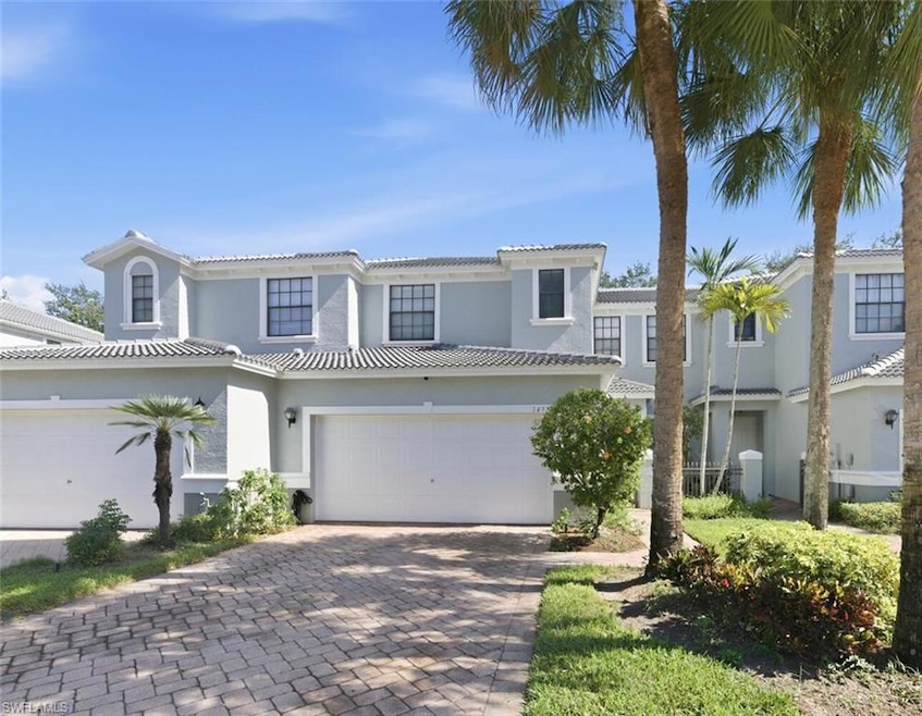 Mediterranean / spanish-style house with decorative driveway, a garage, a tiled roof, and stucco siding