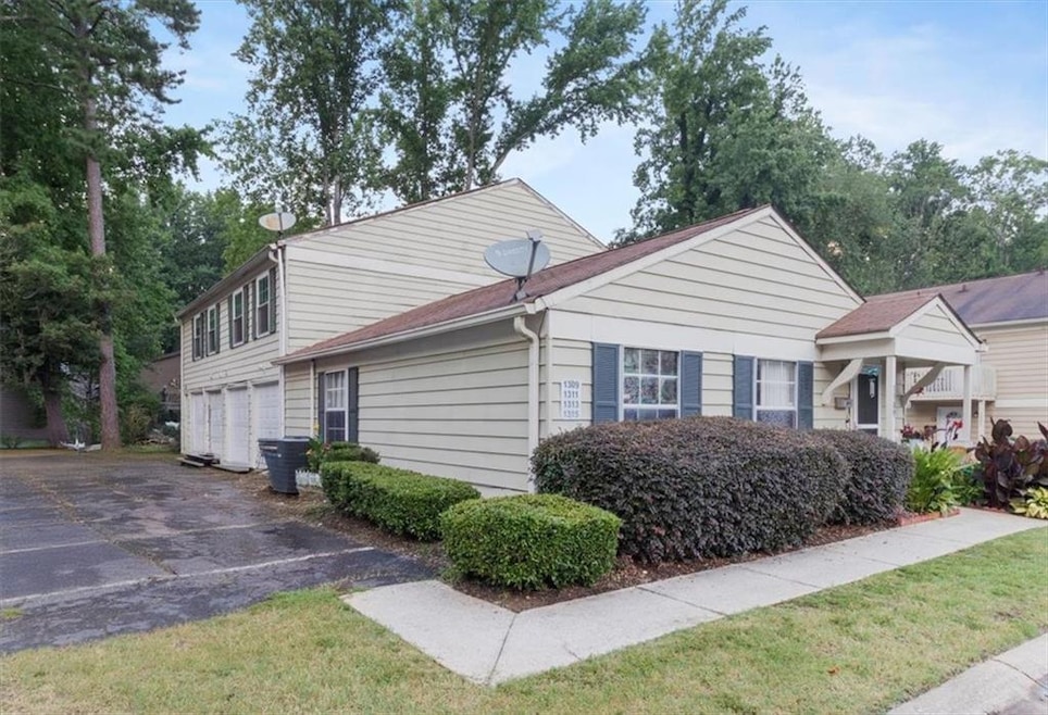View of side of property featuring driveway and an attached garage