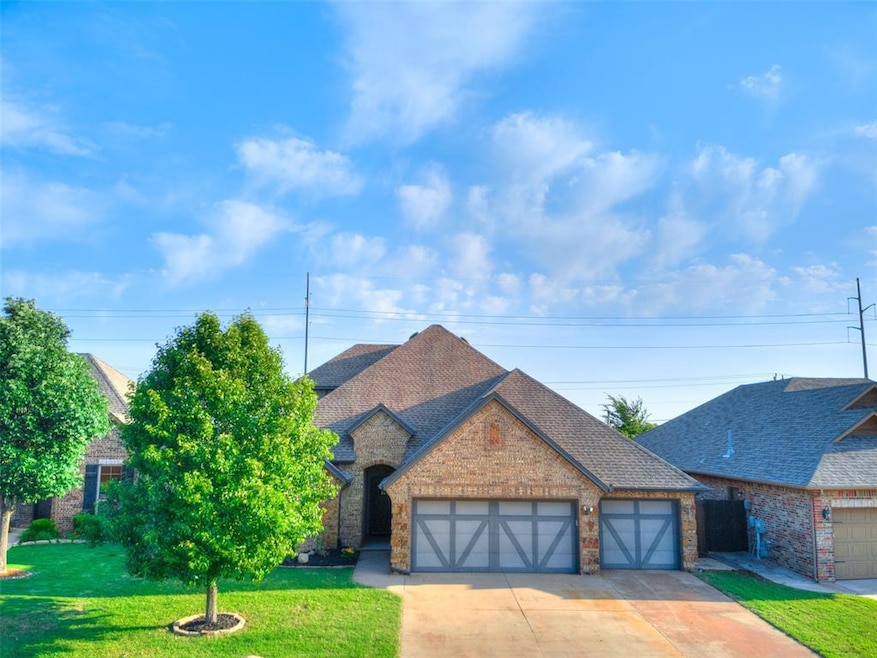 View of front of property with an attached garage, brick siding, a front yard, concrete driveway, and roof with shingles