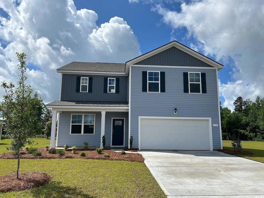 View of front of home with a garage, driveway, a front yard, a porch, and roof with shingles