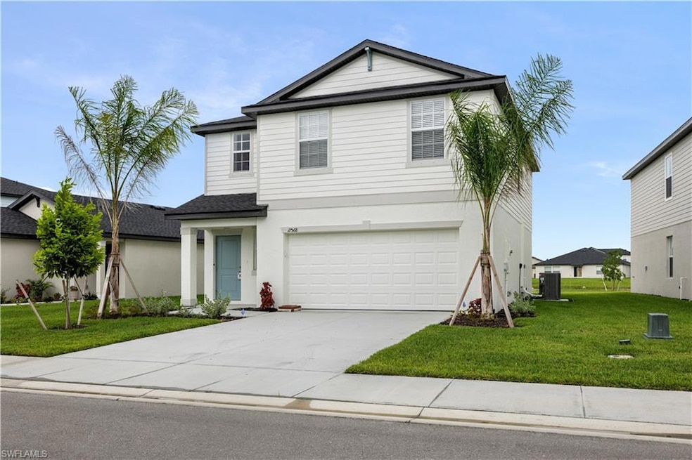 Traditional home with concrete driveway, a front yard, an attached garage, stucco siding, and a shingled roof