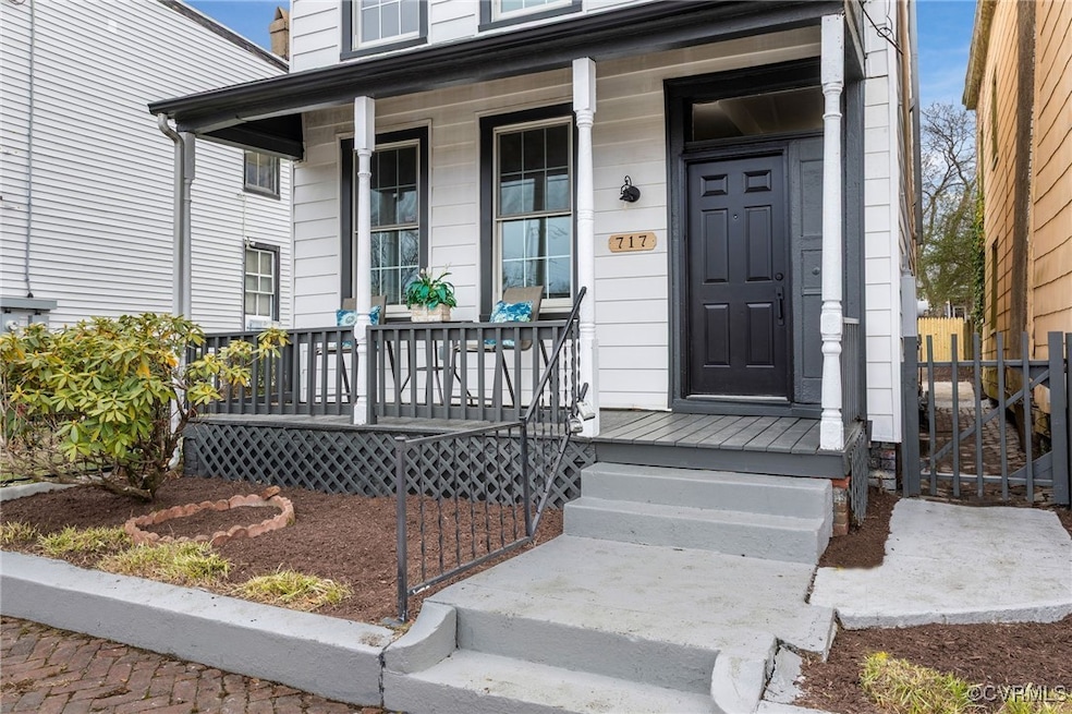 Entrance to property featuring covered porch