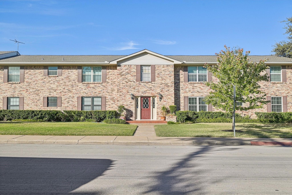 Multi unit property featuring brick siding and a f