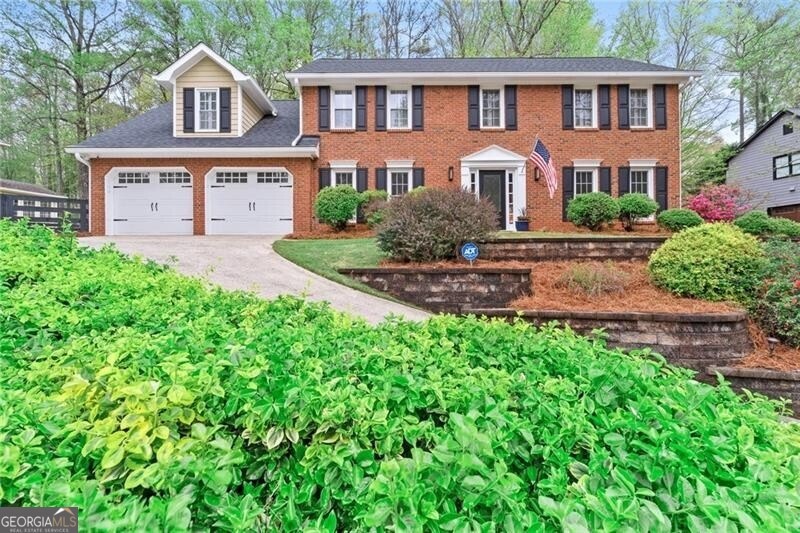 Colonial home featuring a two car garage