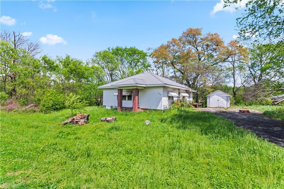 View of front of home with an outdoor structure an
