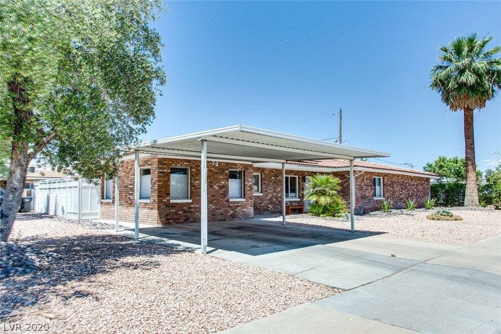 Exterior Front of home with 2-car carport, desert