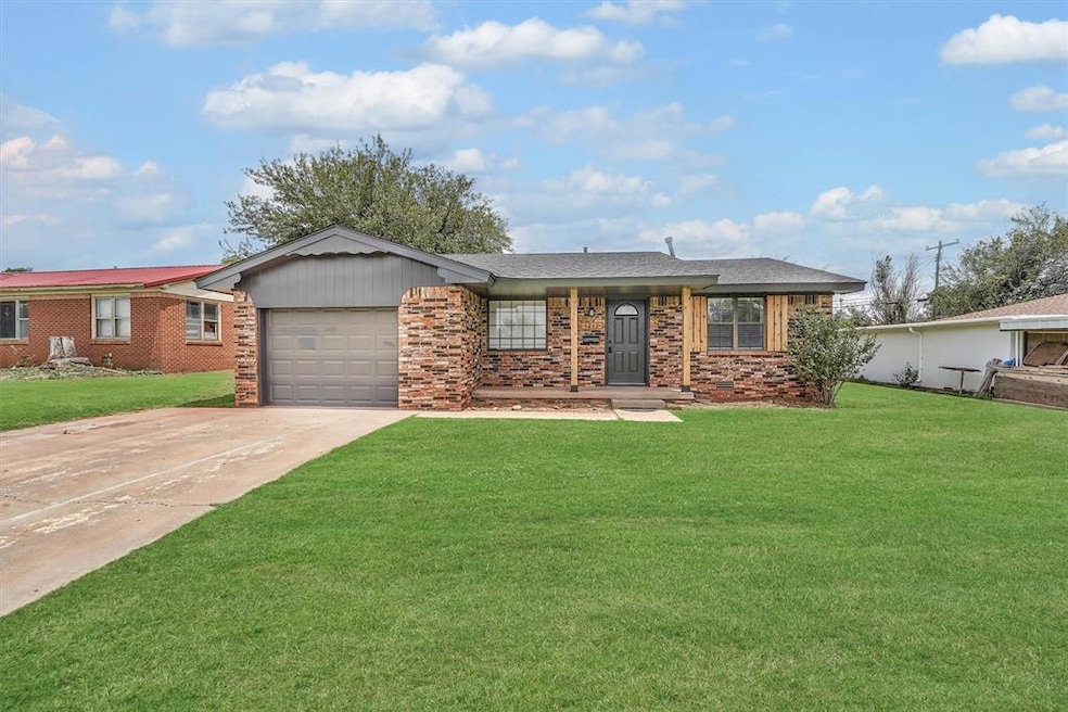 Brick home in Sayre, OK with garage, front porch and concrete driveway