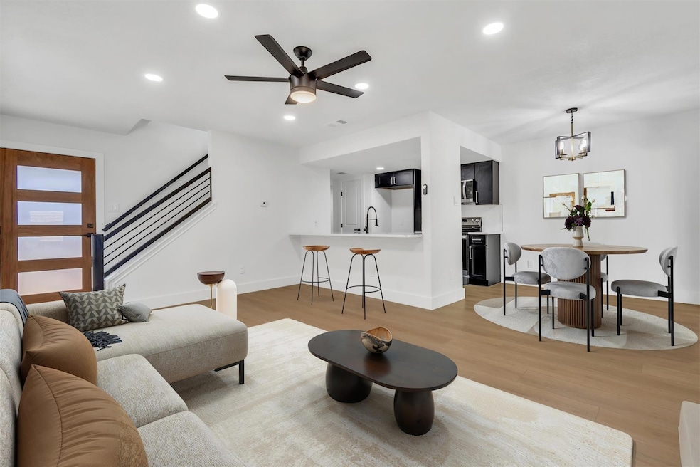 Living area featuring stairs, light wood-type flo