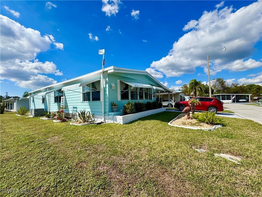View of home's exterior featuring a yard and drive