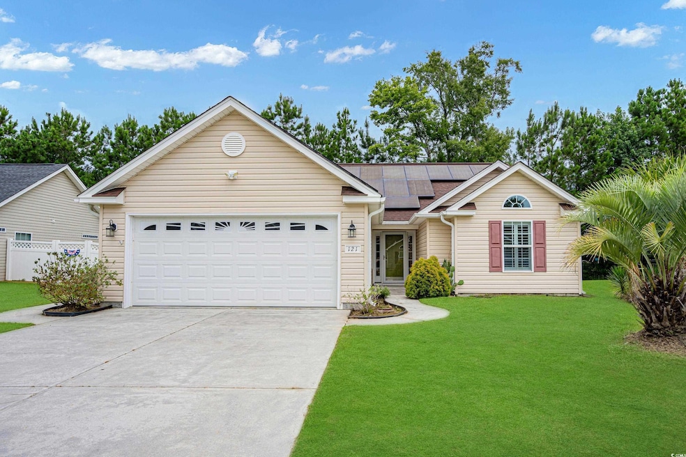 Ranch-style house featuring a garage, a front lawn