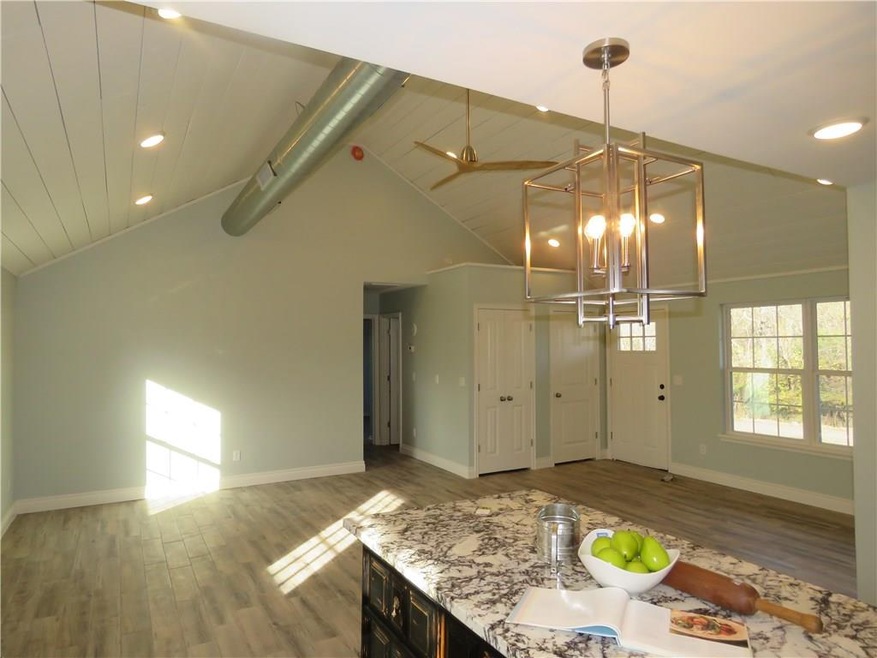 View of living area from kitchen.  Double doors are the laundry room for stackables.