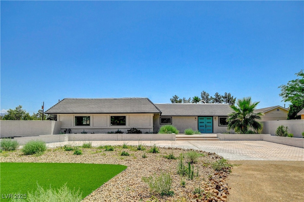 View of front of home with french doors, driveway,