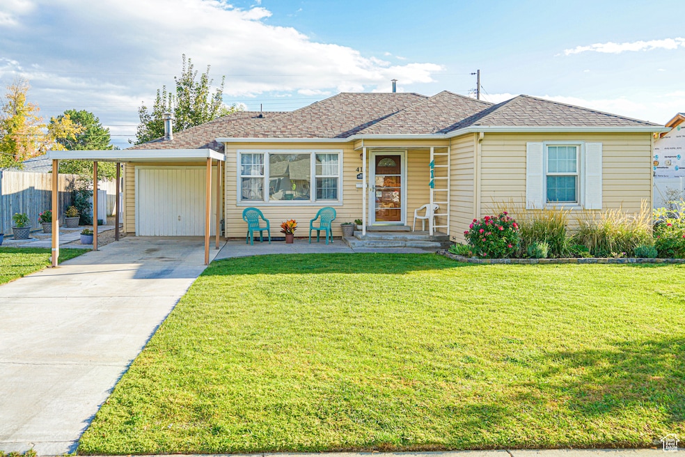 Bungalow-style house with roof with shingles, concrete driveway, and a carport