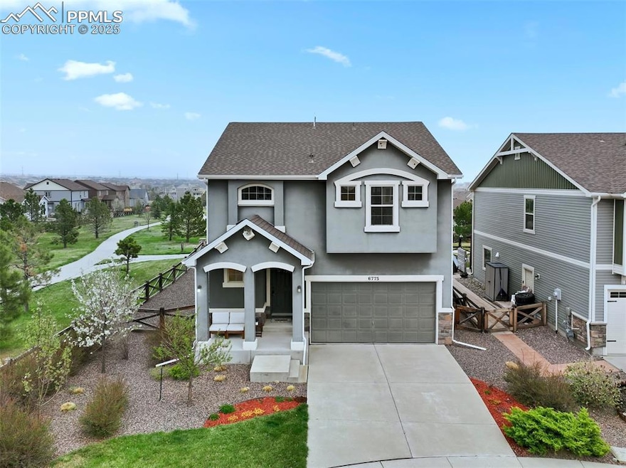 Craftsman inspired home featuring a garage, covered porch, driveway, stucco siding, and fence