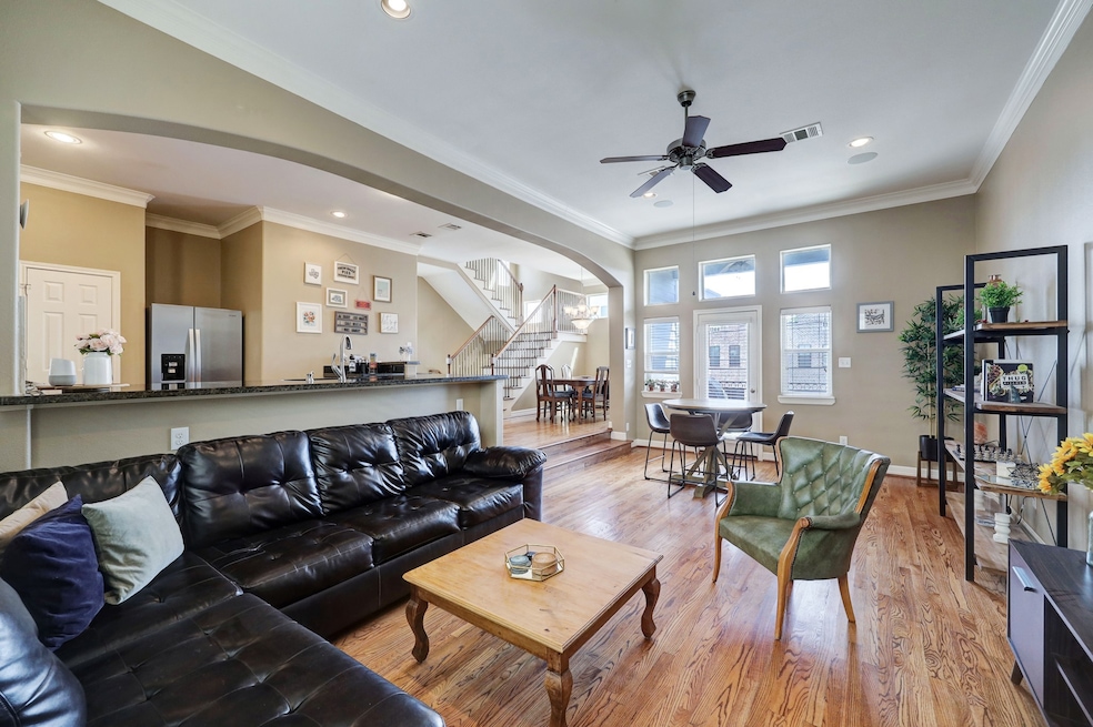Spacious living room features hardwood floors, bui