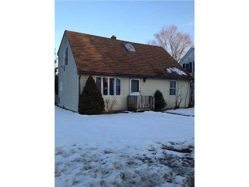 Exterior Front. Pale Yellow Vinyl Siding.