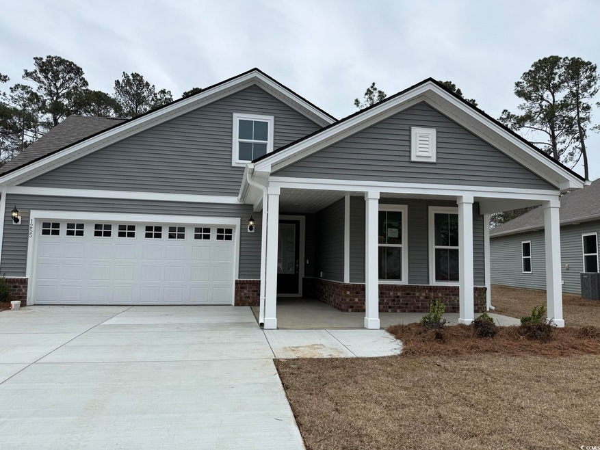 View of front facade featuring a garage and a front yard