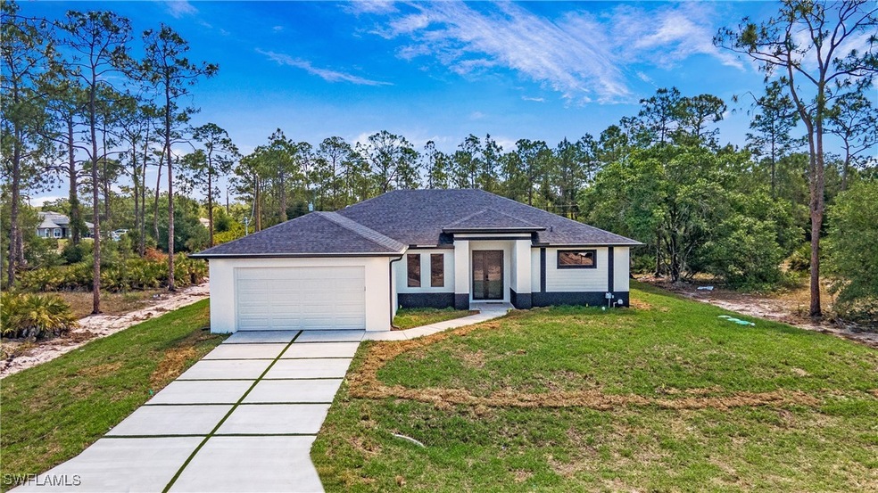 Ranch-style home with a garage, a front lawn, driv