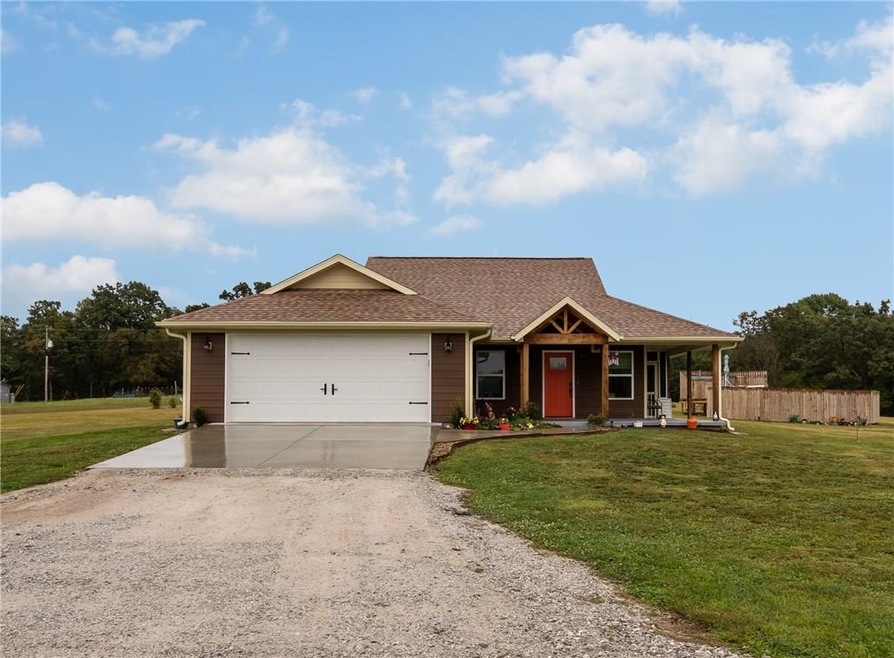 Front exterior with beautiful entry! Pool in dista
