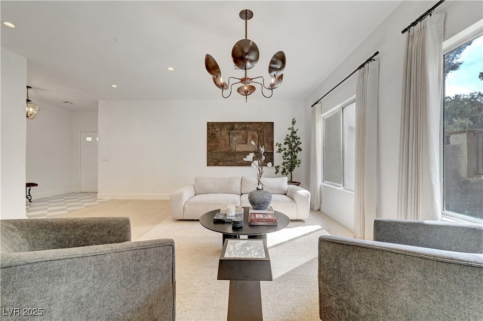 Living room with a chandelier, recessed lighting,