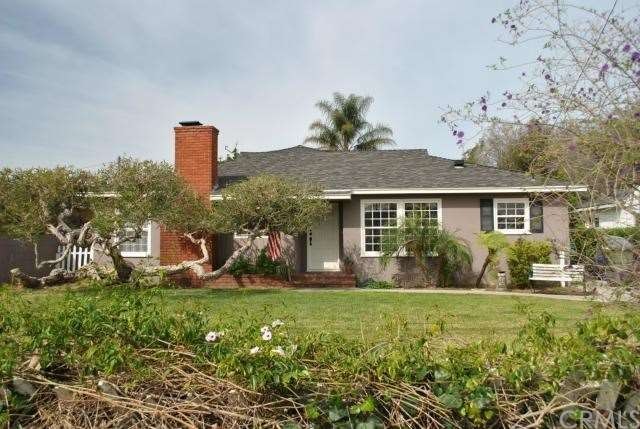 Picket fence and large front lawn, house sit back 