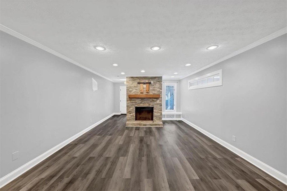 Unfurnished living room featuring dark hardwood / 