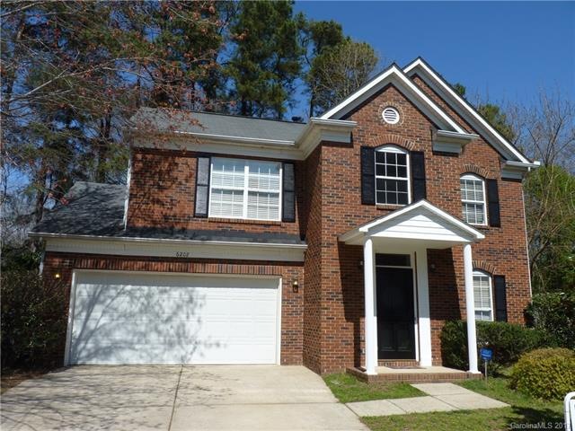 Front showing brick and garage