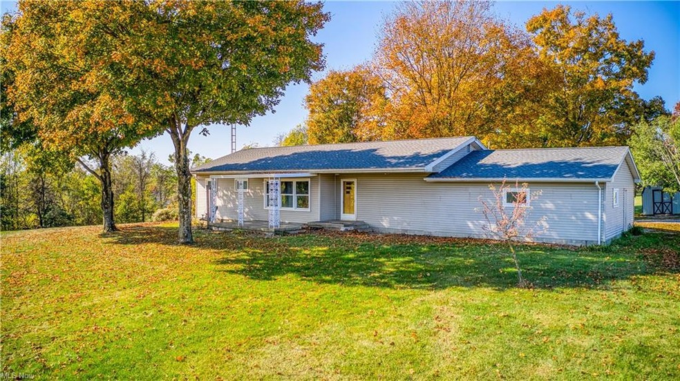Ranch-style home featuring a front lawn