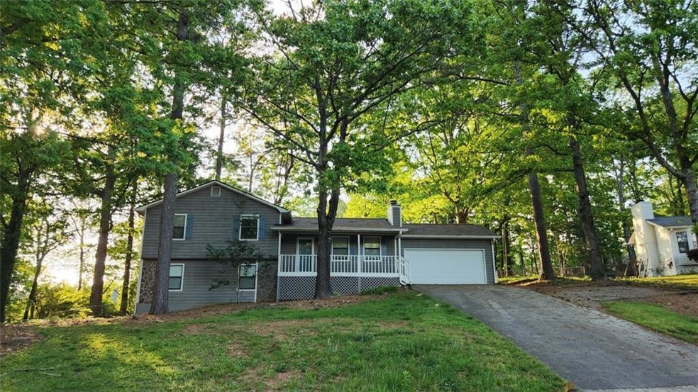 Split level home with a garage, a front lawn, and 