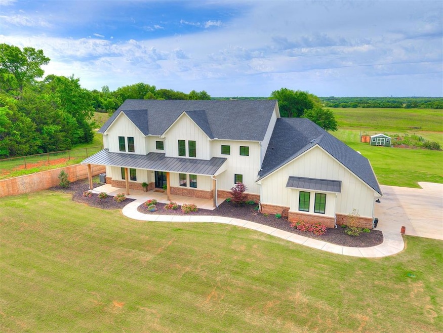 Modern farmhouse featuring a standing seam roof, a